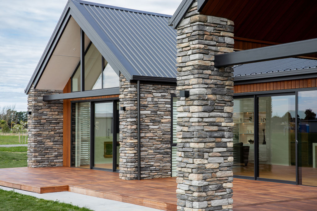 New home exterior with schist stone pillars and cedar cladding by Mt Hutt Construction